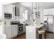 A modern kitchen with stainless steel appliances, gray cabinets, white countertops, and hanging pendant lights at 1364 Westboro Sw Dr, Atlanta, GA 30310