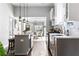 Modern kitchen with gray cabinets and stainless steel appliances, open to dining room at 1364 Westboro Sw Dr, Atlanta, GA 30310