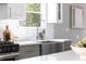 Kitchen featuring a stainless steel farmhouse sink, white subway tile backsplash, and stainless steel oven at 1364 Westboro Sw Dr, Atlanta, GA 30310