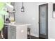 A gray-framed glass pantry door with a charming graphic and the word 
