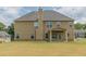 Spacious backyard with covered patio offers ample space for outdoor activities at 171 Osier Dr, Mcdonough, GA 30252