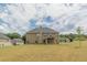 Large backyard featuring lush green grass, and a covered patio perfect for entertaining at 171 Osier Dr, Mcdonough, GA 30252