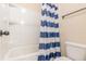 Bathroom includes a shower and tub combination featuring a blue and white curtain at 171 Osier Dr, Mcdonough, GA 30252