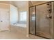 Bathroom featuring a glass shower, tile surround, soaking tub, and tiled floors at 171 Osier Dr, Mcdonough, GA 30252