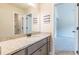 Bathroom with granite countertops, wood cabinets, large mirror and access to bedroom at 171 Osier Dr, Mcdonough, GA 30252