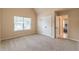 Bedroom showcasing carpet, walk-in closet, tray ceiling, and a large window at 171 Osier Dr, Mcdonough, GA 30252
