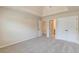 Neutral bedroom featuring carpet, tray ceiling, walk-in closet, and ensuite bath access at 171 Osier Dr, Mcdonough, GA 30252