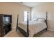 Bedroom featuring a four poster bed, a TV stand, a window, and carpeted floor at 171 Osier Dr, Mcdonough, GA 30252