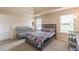 Cozy bedroom featuring carpeted floors, a comfortable bed, and abundant natural light at 171 Osier Dr, Mcdonough, GA 30252