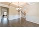 Dining room with decorative molding, chandelier, and stairs at 171 Osier Dr, Mcdonough, GA 30252