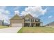 Beautiful two-story home with a two-car garage, covered porch, and manicured lawn at 171 Osier Dr, Mcdonough, GA 30252