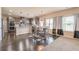 Eat-in kitchen featuring stainless steel appliances, wood flooring, granite countertops, and lots of natural light at 171 Osier Dr, Mcdonough, GA 30252