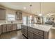 Spacious kitchen with island featuring granite countertops and stainless steel appliances at 171 Osier Dr, Mcdonough, GA 30252