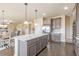 Open kitchen featuring stainless steel appliances, a spacious island, granite countertops, and modern cabinetry at 171 Osier Dr, Mcdonough, GA 30252