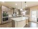 Charming kitchen featuring stainless steel appliances, granite countertops, and wood floors at 171 Osier Dr, Mcdonough, GA 30252