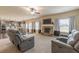 Open-concept living room featuring a stone fireplace and view to the kitchen at 171 Osier Dr, Mcdonough, GA 30252
