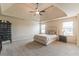 Main bedroom features a trey ceiling, carpet, a ceiling fan and two large windows at 171 Osier Dr, Mcdonough, GA 30252