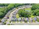 Aerial view of homes nestled among trees and a pond in the neighborhood at 180 Mirramont Lake Dr, Woodstock, GA 30189