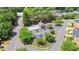 Aerial view of the community pool and clubhouse surrounded by lush landscaping and mature trees at 180 Mirramont Lake Dr, Woodstock, GA 30189