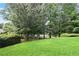 Lush green backyard with mature trees and manicured landscaping, perfect for relaxing outdoors at 180 Mirramont Lake Dr, Woodstock, GA 30189