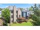 Exterior of home with a wooden deck and stairs leading to a bricked patio and lawn at 180 Mirramont Lake Dr, Woodstock, GA 30189