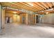 Unfinished basement with exposed wooden beams and concrete flooring, ready to be finished at 180 Mirramont Lake Dr, Woodstock, GA 30189