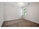 This bedroom offers neutral walls, cozy carpet, and natural light from the bright window at 180 Mirramont Lake Dr, Woodstock, GA 30189