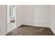 Walk-in closet features installed shelving, neutral walls, and carpeted floors at 180 Mirramont Lake Dr, Woodstock, GA 30189