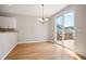 Light filled dining room with hardwood floors and access to the outdoor deck at 180 Mirramont Lake Dr, Woodstock, GA 30189