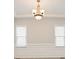 Bright dining room featuring two windows, white wainscoting and molding, and modern lighting fixture at 180 Mirramont Lake Dr, Woodstock, GA 30189