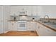 Kitchen with white cabinets, stainless steel appliances, and wood countertops at 180 Mirramont Lake Dr, Woodstock, GA 30189
