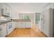 Open kitchen with white cabinets and appliances, bright and airy view at 180 Mirramont Lake Dr, Woodstock, GA 30189