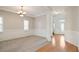 Spacious living room with neutral paint, carpet, and lots of natural light at 180 Mirramont Lake Dr, Woodstock, GA 30189