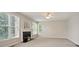 Cozy living room featuring a fireplace and large windows for natural light at 180 Mirramont Lake Dr, Woodstock, GA 30189