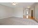 Bright living room with carpet, neutral paint, and an open layout at 180 Mirramont Lake Dr, Woodstock, GA 30189
