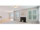 Bright living room with a fireplace, large windows, and ceiling fan at 180 Mirramont Lake Dr, Woodstock, GA 30189