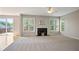 Comfortable living room with a fireplace, carpeted floors, and natural light at 180 Mirramont Lake Dr, Woodstock, GA 30189