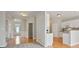Open-concept living room, hardwood floors, neutral paint, and access to the kitchen at 180 Mirramont Lake Dr, Woodstock, GA 30189
