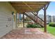 Brick patio area beneath the deck, leading to yard with a great outdoor view at 180 Mirramont Lake Dr, Woodstock, GA 30189