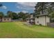 Spacious backyard with mature trees, green lawn, patio, wooden fence and storage shed at 2324 Ithica Se Dr, Marietta, GA 30067