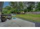 Spacious backyard features a patio, green lawn, mature trees, and playground equipment for enjoyment at 2324 Ithica Se Dr, Marietta, GA 30067