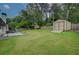 Lush backyard with storage shed, play house, green lawn, wooden fence and patio area at 2324 Ithica Se Dr, Marietta, GA 30067