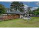 Well maintained backyard featuring patio, wooden fence, mature trees, lush green lawn and covered parking at 2324 Ithica Se Dr, Marietta, GA 30067