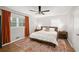 Cozy bedroom features hardwood floors, natural light, a ceiling fan and neutral color scheme at 2324 Ithica Se Dr, Marietta, GA 30067