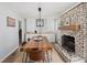 Cozy dining room featuring a brick fireplace, a wooden table, and built-in cabinets at 2324 Ithica Se Dr, Marietta, GA 30067