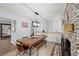 Charming dining area with brick fireplace, stylish lighting, and a wooden table at 2324 Ithica Se Dr, Marietta, GA 30067