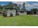 Charming two-story home featuring a red front door, white brick, a carport, and a lush green front yard at 2324 Ithica Se Dr, Marietta, GA 30067