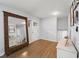 Welcoming foyer with hardwood floors, a white door, a decorative mirror, and a glimpse of the staircase at 2324 Ithica Se Dr, Marietta, GA 30067