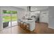 Modern kitchen features a granite island, stainless steel appliances, and access to backyard at 2324 Ithica Se Dr, Marietta, GA 30067