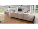 Bright living room showcasing hardwood floors, a neutral sectional, white cabinets, and an open view to the kitchen at 2324 Ithica Se Dr, Marietta, GA 30067